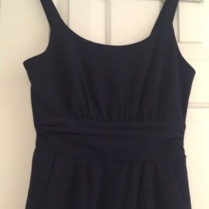 Navy romper, flattering waist detail. Small.